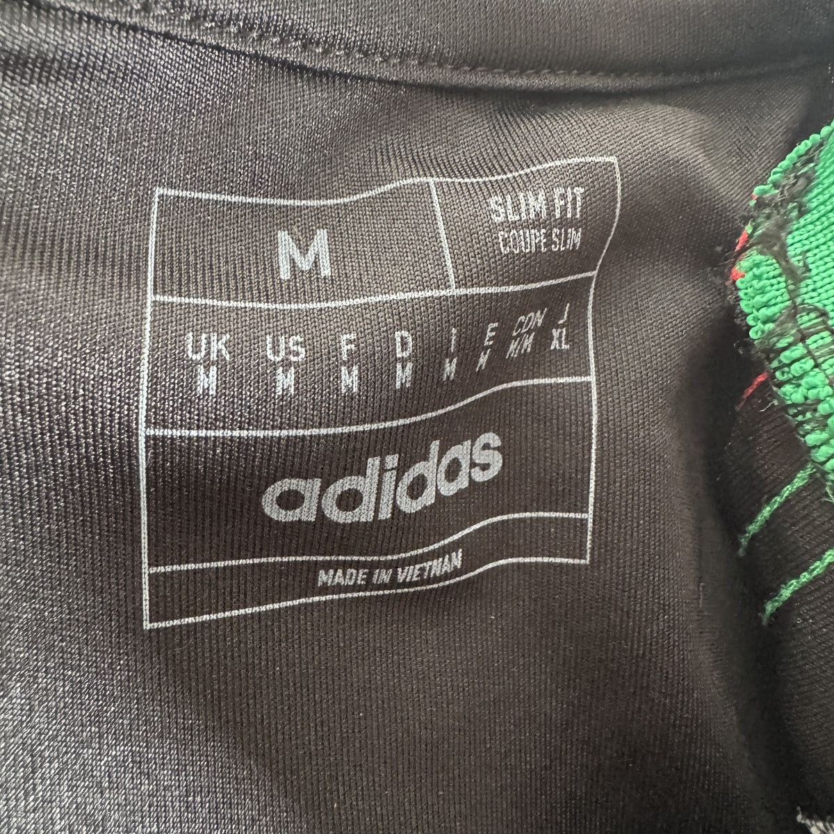 Size label inside Arsenal 2024/2025 away football shirt, size Medium