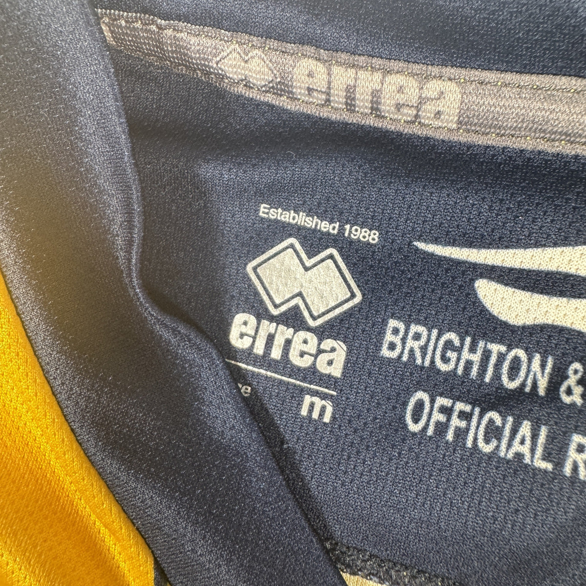 Size label inside Brighton & Hove Albion 2013/2014 away football shirt, size Medium