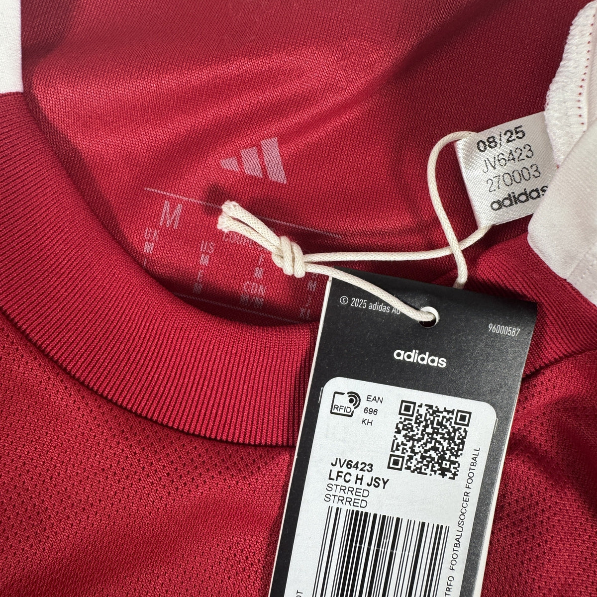 Size label inside Liverpool 2025/2026 home football shirt, size Medium