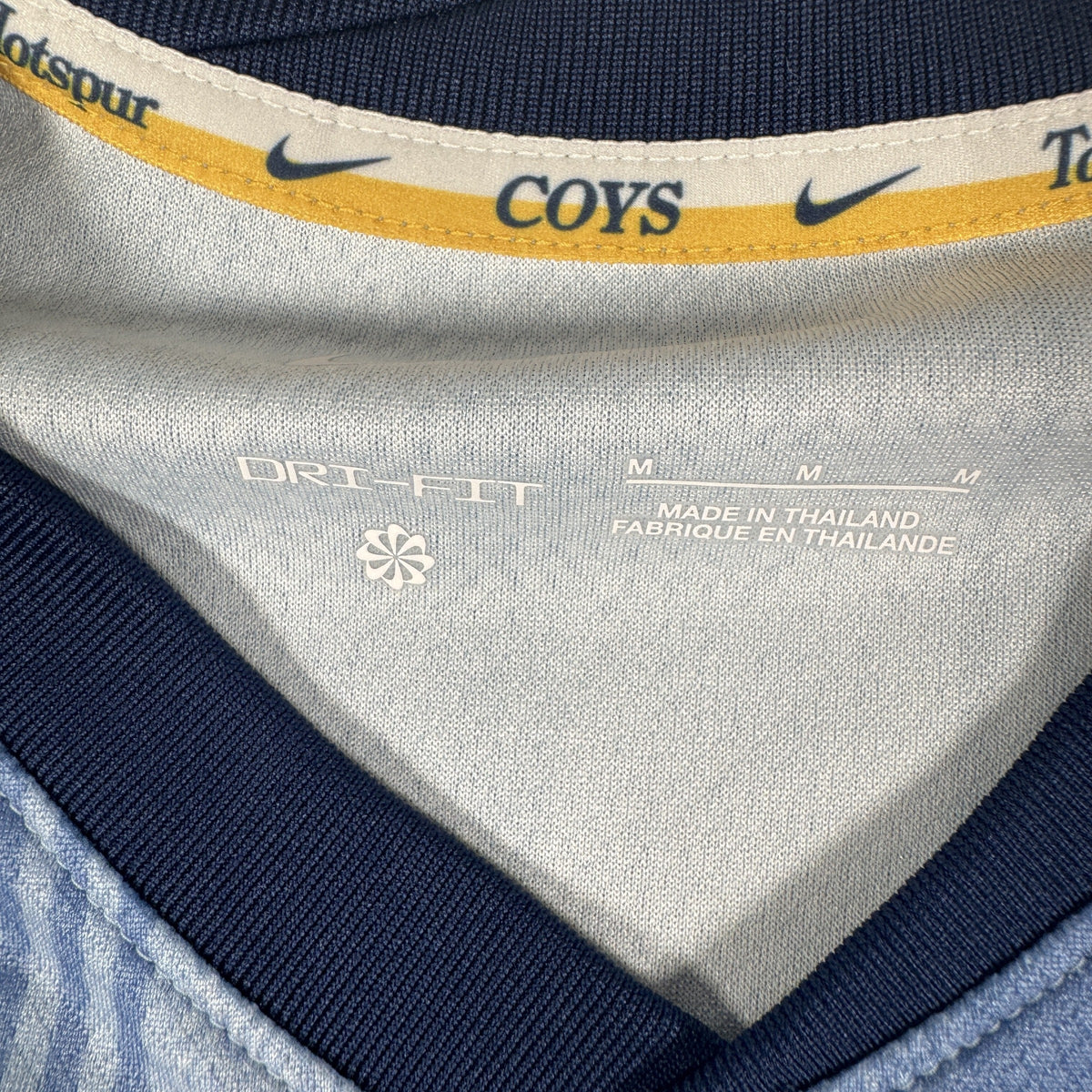 Size label inside Tottenham Hotspur 2024/2025 away football shirt, size Medium